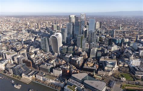 A modern cityscape view of London, featuring several prominent office buildings, symbolizing the UK's bustling tech industry.