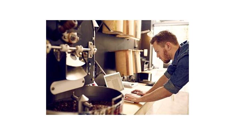 Small business owner using laptop for payroll in the UK