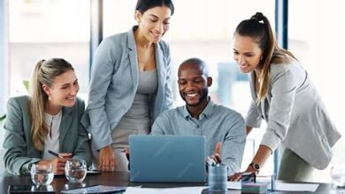 A diverse team collaborating on software development with a subtle UK map overlay in the background, illustrating the nationwide impact of UK software development companies.