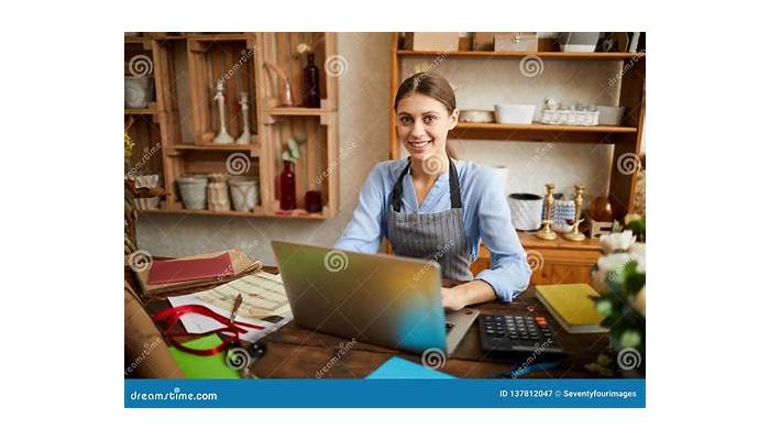 Small business owner reviewing financial data on a laptop.